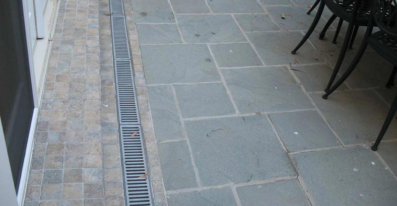 Patio drainage solutions enclosed